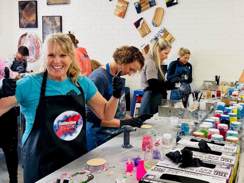 A group of women making resin boards at a workshop